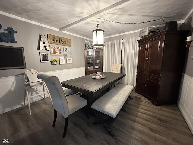 dining space featuring dark wood-type flooring and crown molding