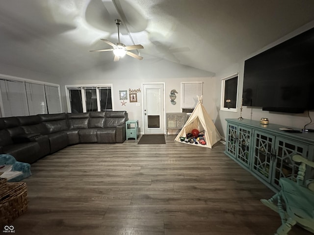 living room featuring ceiling fan, hardwood / wood-style floors, and lofted ceiling