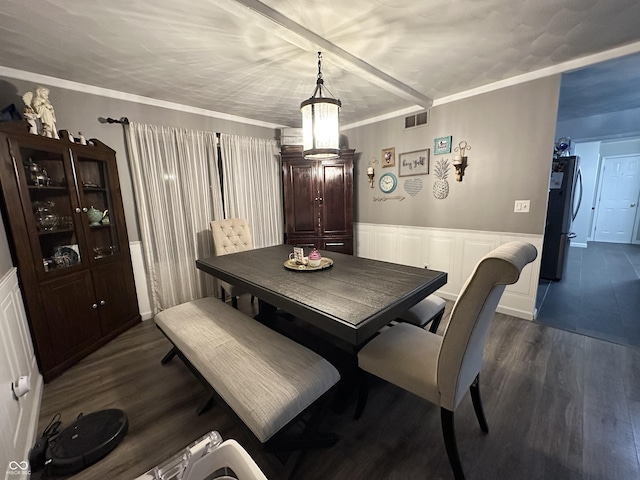 dining room featuring dark hardwood / wood-style floors, crown molding, and a chandelier