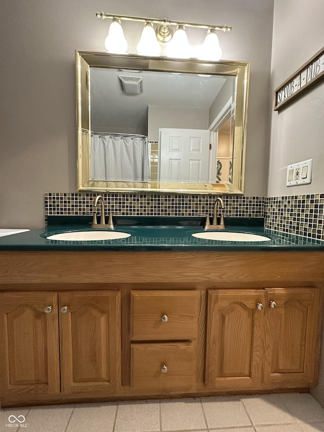 bathroom featuring decorative backsplash, tile patterned floors, and vanity