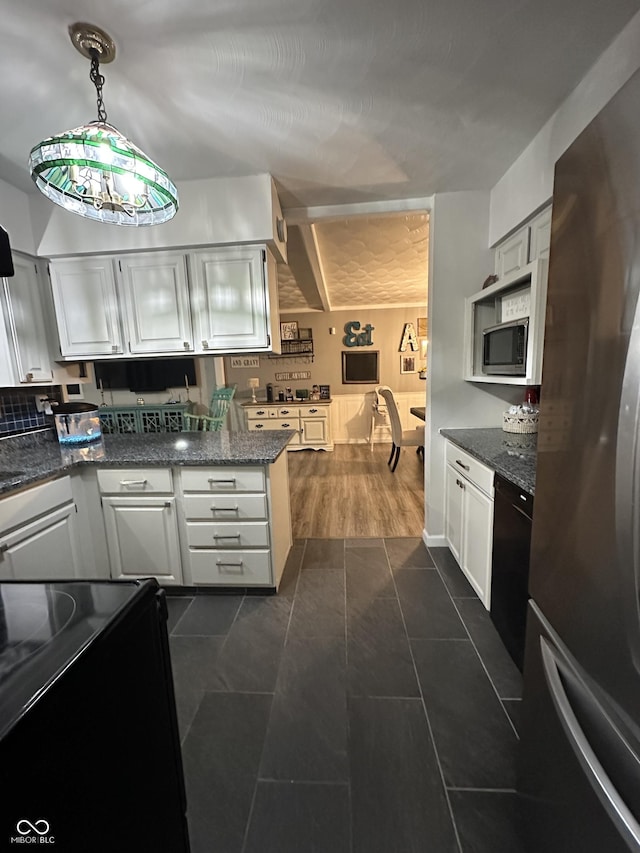 kitchen with white cabinets, pendant lighting, appliances with stainless steel finishes, and dark stone counters