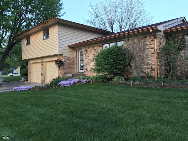 split level home with a front lawn and a garage