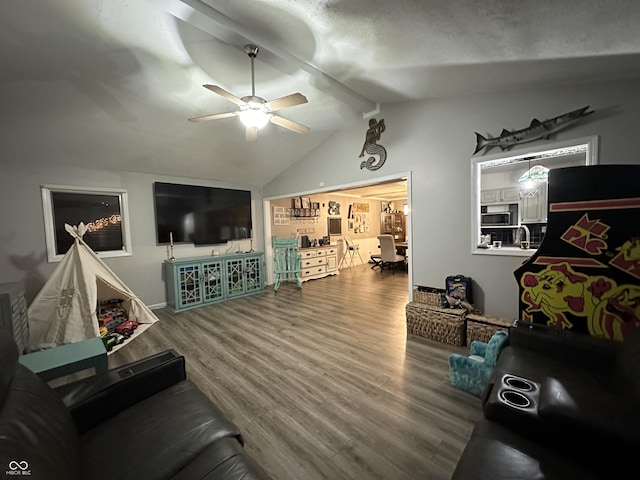 living room featuring ceiling fan, hardwood / wood-style floors, and lofted ceiling with beams