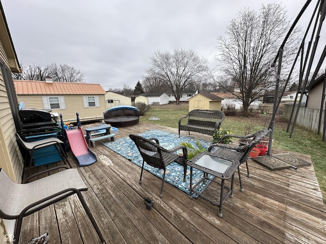 wooden deck with a storage shed