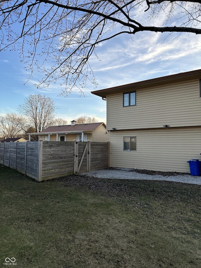 back of house featuring a yard