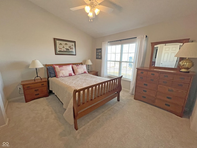 bedroom with light carpet, vaulted ceiling, and ceiling fan