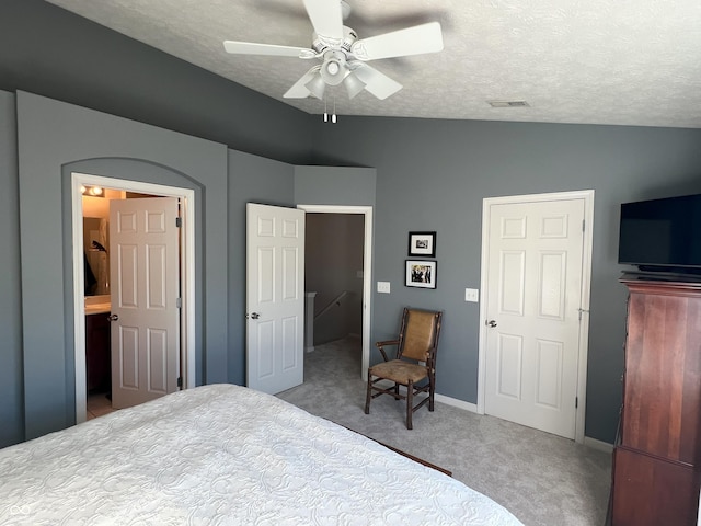 bedroom with a textured ceiling, carpet floors, ceiling fan, and vaulted ceiling