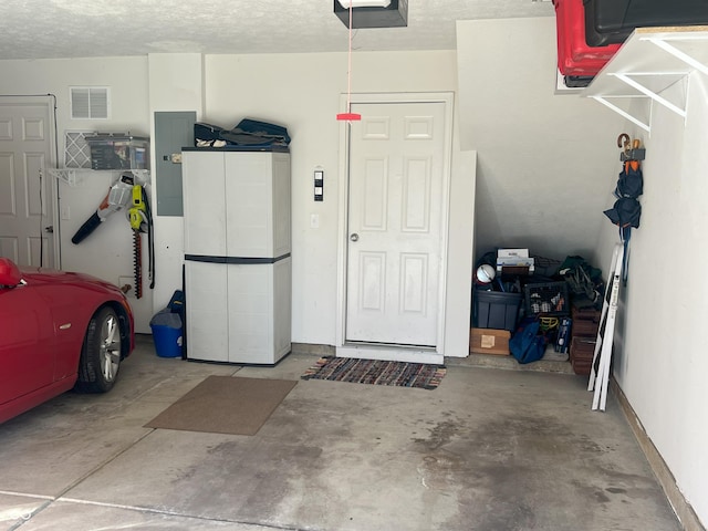 garage featuring a garage door opener and electric panel