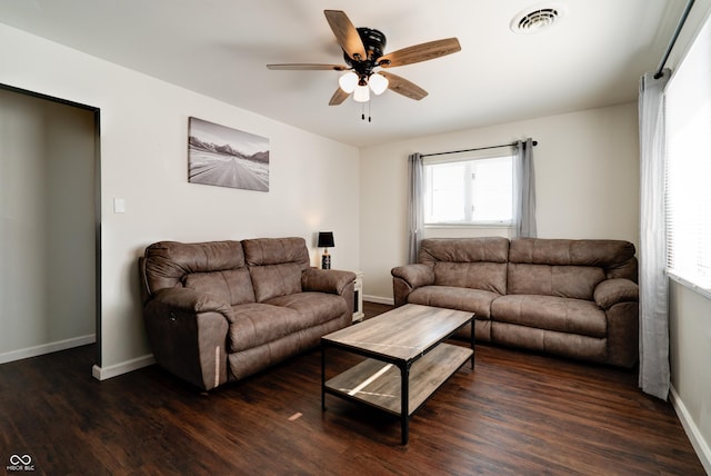 living room featuring ceiling fan and dark hardwood / wood-style flooring