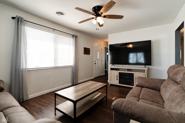 living room with ceiling fan and dark hardwood / wood-style flooring