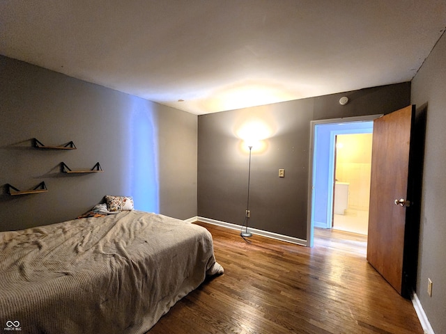 bedroom with baseboards and wood finished floors