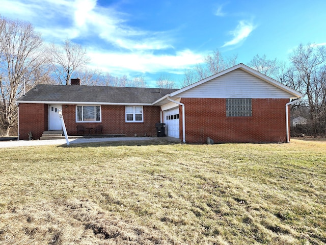 view of front of property with entry steps, a front yard, a garage, brick siding, and a chimney