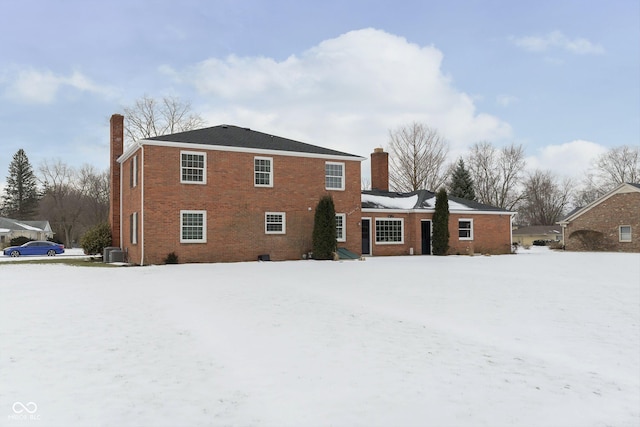 snow covered property featuring central AC