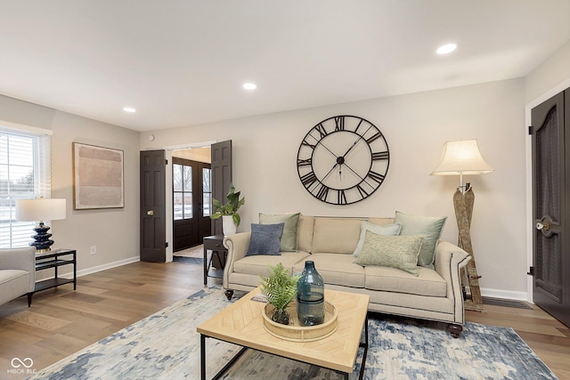 living room featuring light hardwood / wood-style floors and french doors