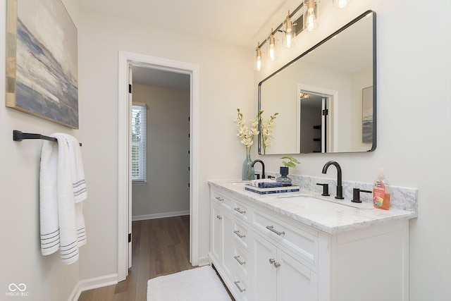 bathroom with hardwood / wood-style flooring and vanity