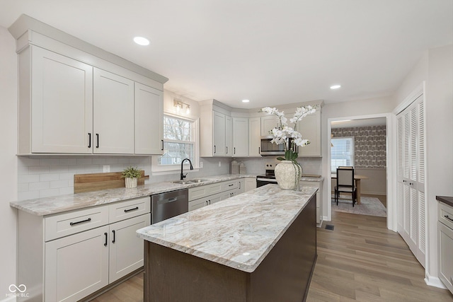 kitchen with white cabinetry, sink, decorative backsplash, and appliances with stainless steel finishes