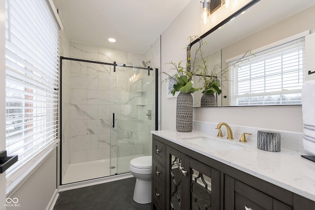 bathroom featuring walk in shower, vanity, toilet, and tile patterned flooring