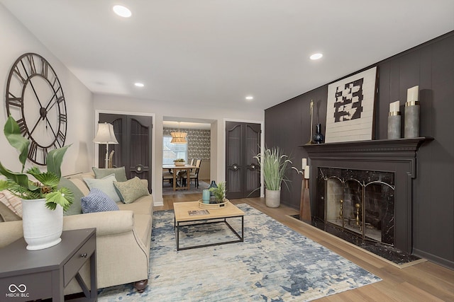 living room with a large fireplace and light wood-type flooring