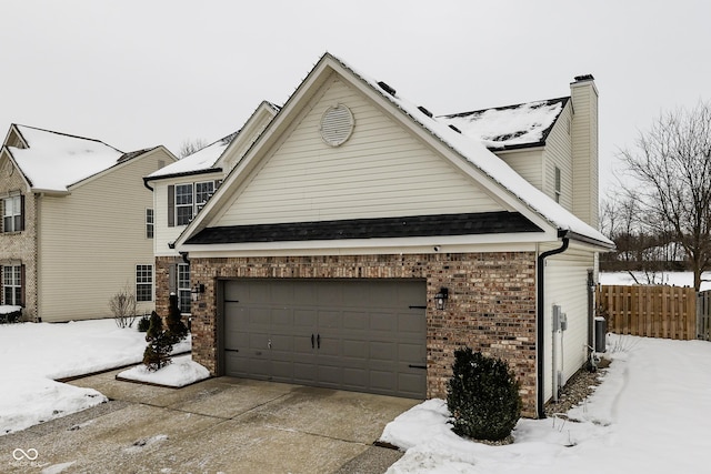 view of snow covered exterior featuring a garage