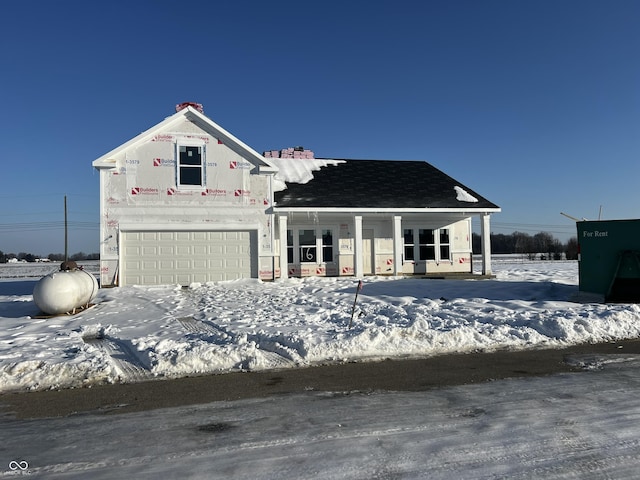 unfinished property with covered porch and a garage