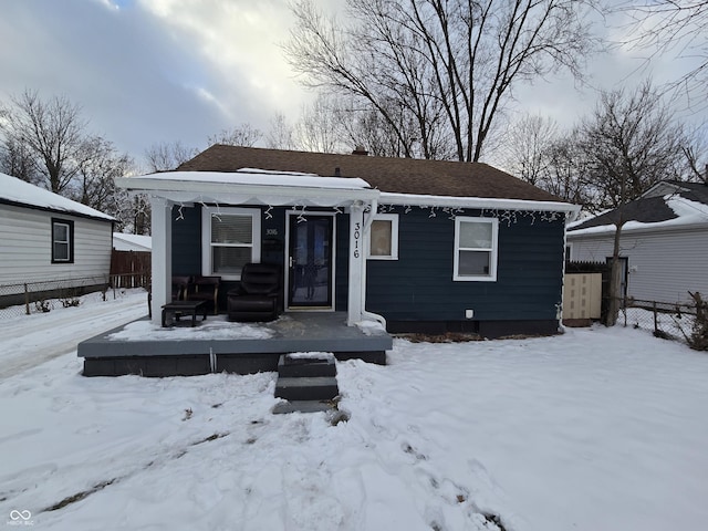 view of snow covered back of property