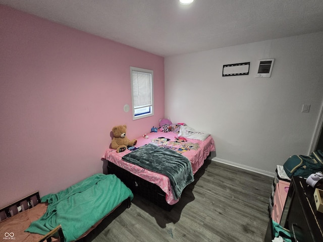 bedroom featuring dark hardwood / wood-style flooring