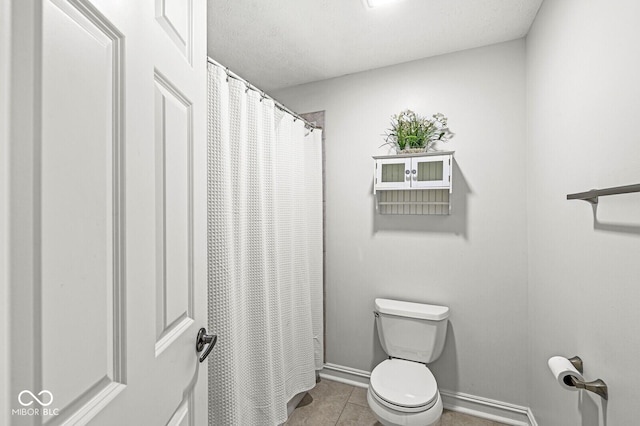 bathroom featuring tile patterned flooring and toilet