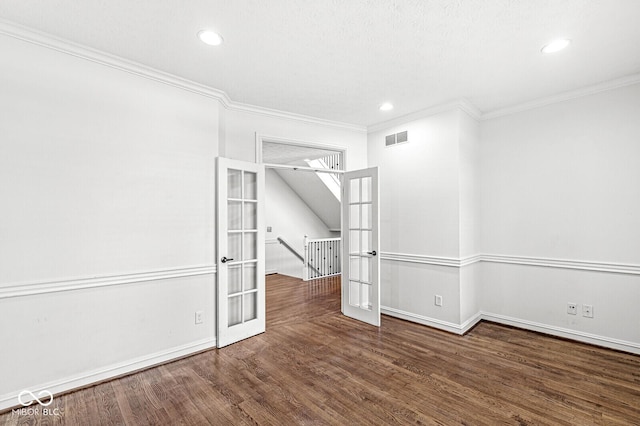 spare room with ornamental molding, dark wood-type flooring, and french doors