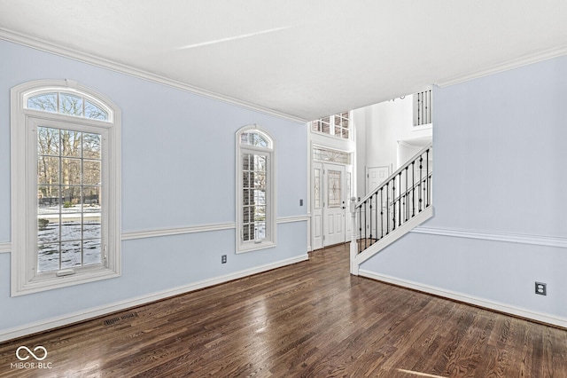 foyer entrance with dark hardwood / wood-style flooring and crown molding