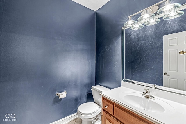 bathroom featuring tile patterned flooring, vanity, and toilet