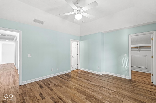 unfurnished bedroom with hardwood / wood-style floors, a closet, and ceiling fan