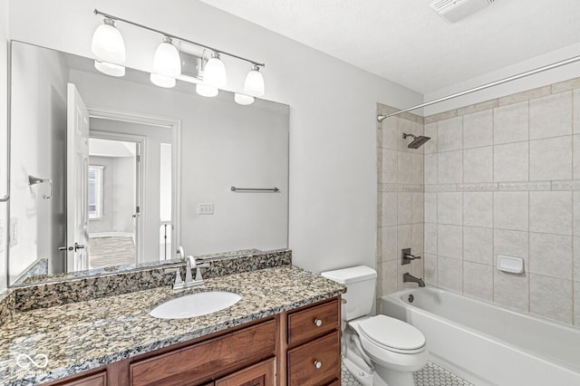 full bathroom with vanity, toilet, and tiled shower / bath