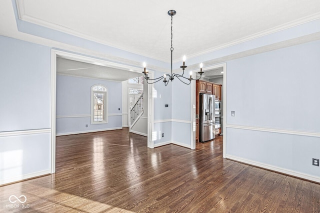 unfurnished dining area with crown molding, dark hardwood / wood-style flooring, and a notable chandelier