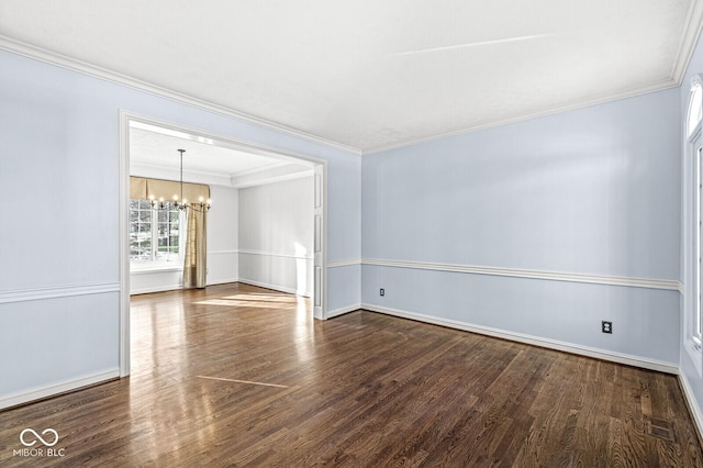 unfurnished room with crown molding, dark wood-type flooring, and an inviting chandelier