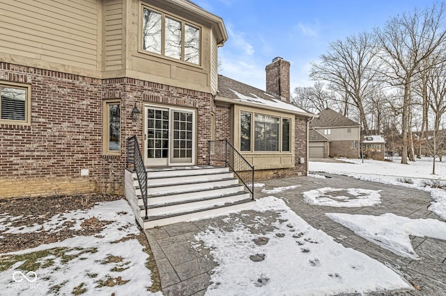 view of snow covered property entrance