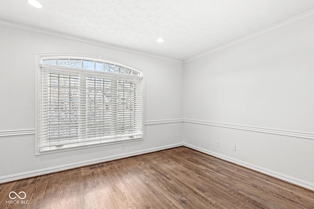 unfurnished room featuring ornamental molding, hardwood / wood-style floors, and a textured ceiling