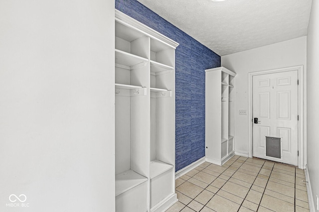 interior space with light tile patterned flooring and a textured ceiling