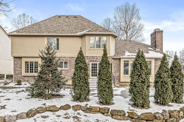 view of snow covered rear of property