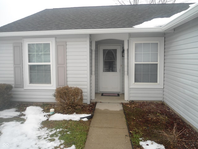 view of snow covered property entrance