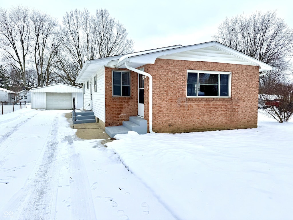 view of front facade with an outdoor structure and a garage