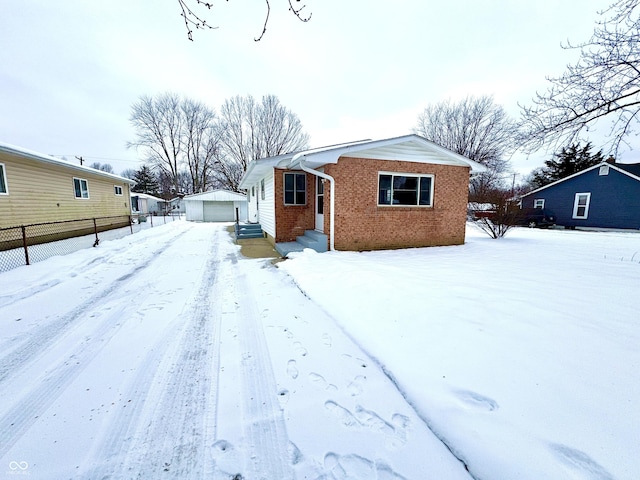 view of front of property with a garage and an outdoor structure