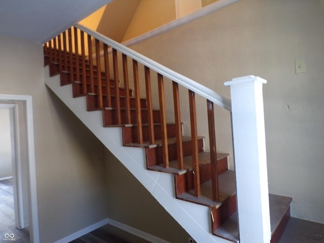 stairs featuring hardwood / wood-style flooring