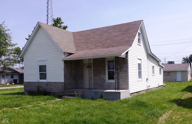 view of front of house with covered porch and a front yard