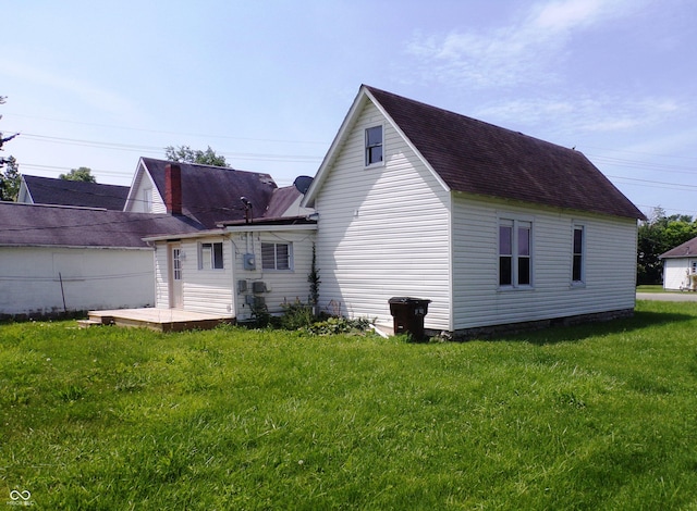 back of property featuring a lawn