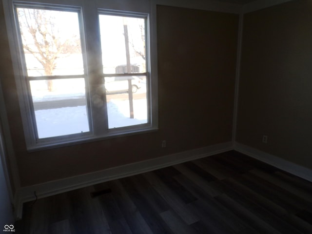 unfurnished room with dark hardwood / wood-style flooring