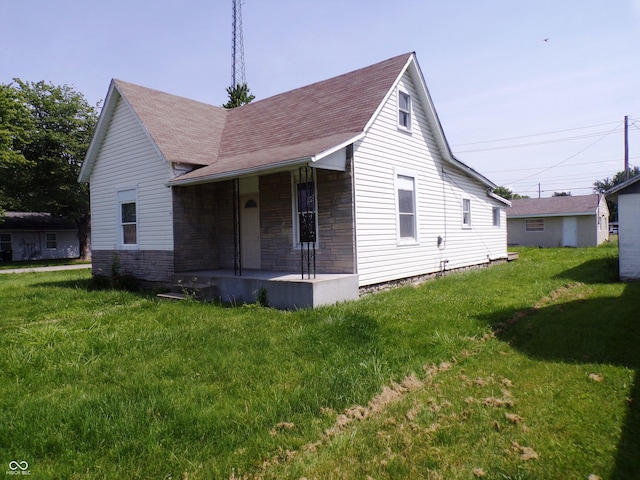 view of front of house with a porch and a front yard