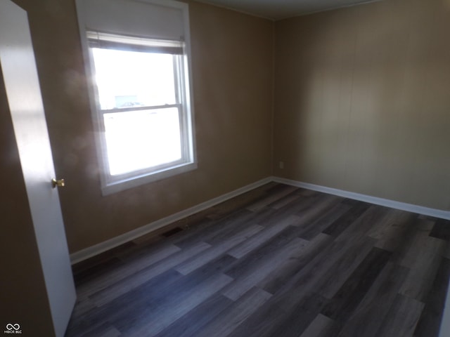 empty room with dark hardwood / wood-style floors