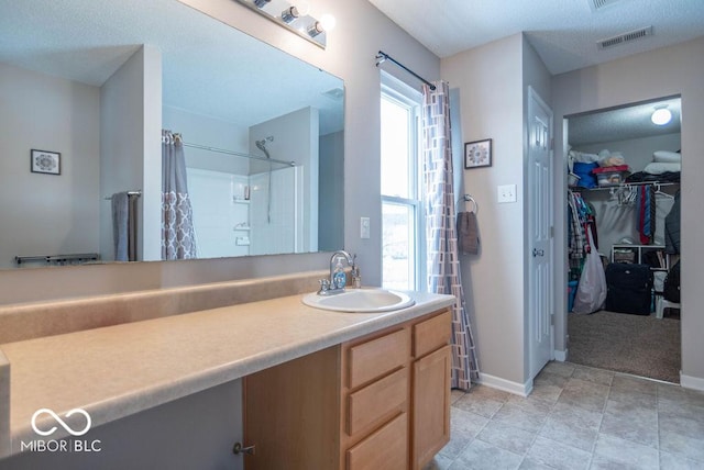 bathroom with vanity and curtained shower