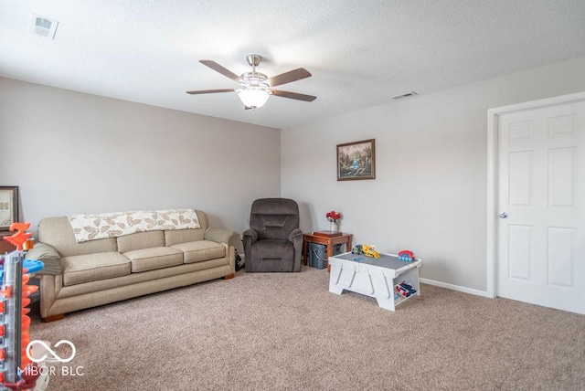 playroom with a textured ceiling, ceiling fan, and carpet