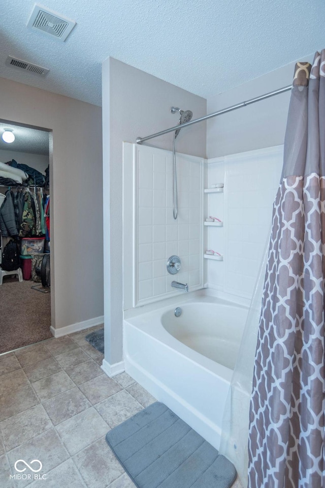 bathroom featuring shower / bath combo with shower curtain and a textured ceiling